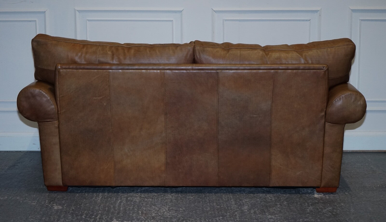 COMFORTABLE BROWN LEATHER TWO TO THREE SEATER SOFA WITH FEATHER BACK CUSHIONS