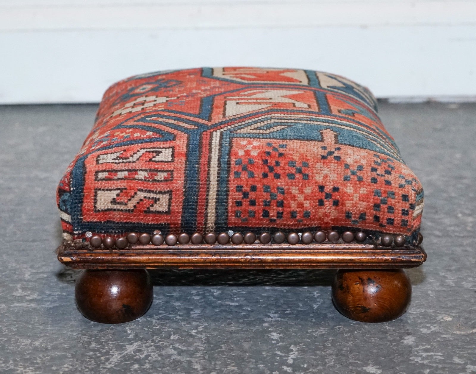 ANTIQUE KILIM TRIBAL RUG UPHOLSTERED FOOTSTOOL RAISED ON BUN FEET WITH STUDS