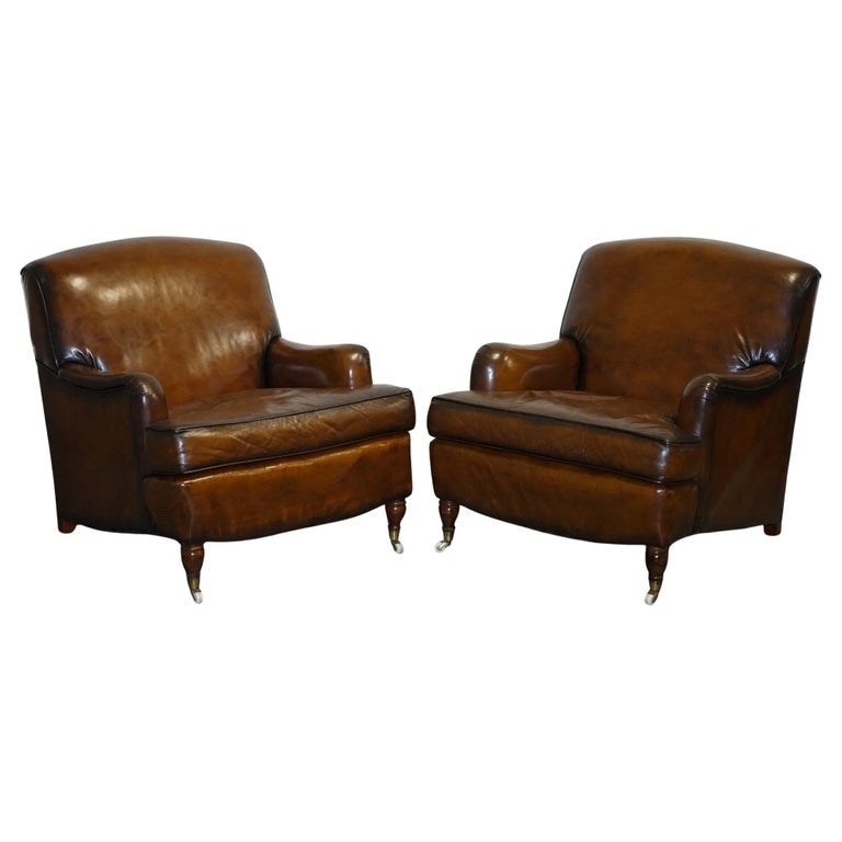 PAIR OF CIGAR HAND DYED LEATHER HOWARD & SONS STYLE ARMCHAIRS ON CASTOR FEET