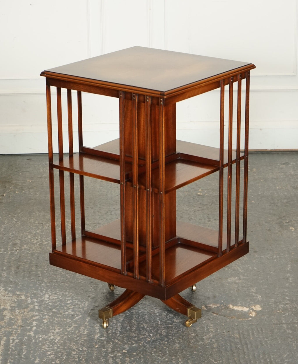 BEVAN FUNNEL REVOLVING BOOKCASE END TABLE RAISED ON BRASS CASTORS