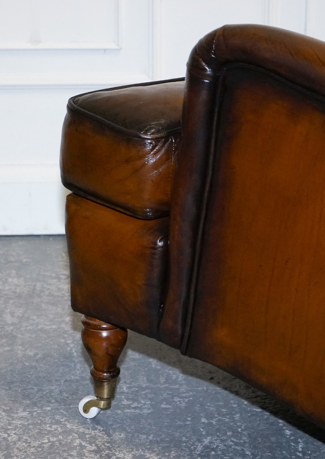 PAIR OF CIGAR HAND DYED LEATHER HOWARD & SONS STYLE ARMCHAIRS ON CASTOR FEET