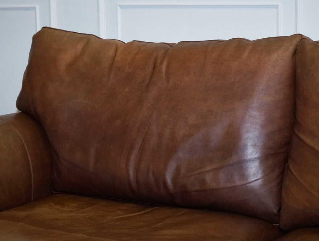 COMFORTABLE BROWN LEATHER TWO TO THREE SEATER SOFA WITH FEATHER BACK CUSHIONS