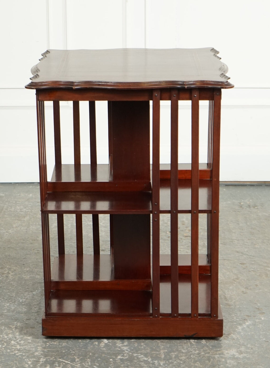 ANTIQUE EDWARDIAN REVOLVING BOOKCASE WITH A SERPENTINE SHAPED TOP