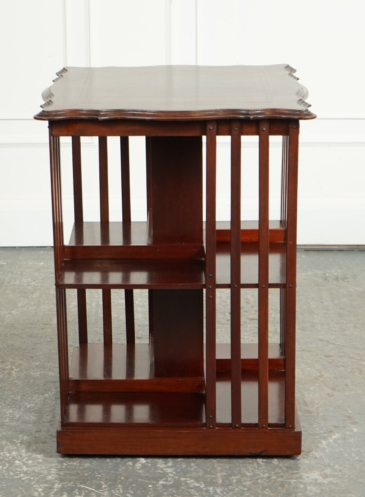 ANTIQUE EDWARDIAN REVOLVING BOOKCASE WITH A SERPENTINE SHAPED TOP