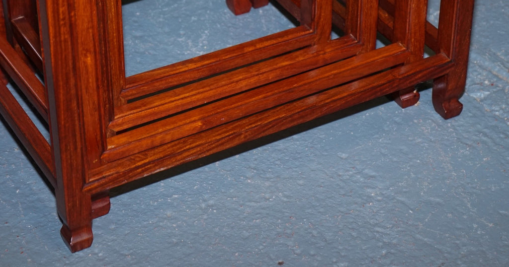 ORIENTAL CHINESE TEAK NEST OF FOUR TABLES WITH CARVED DETAILS