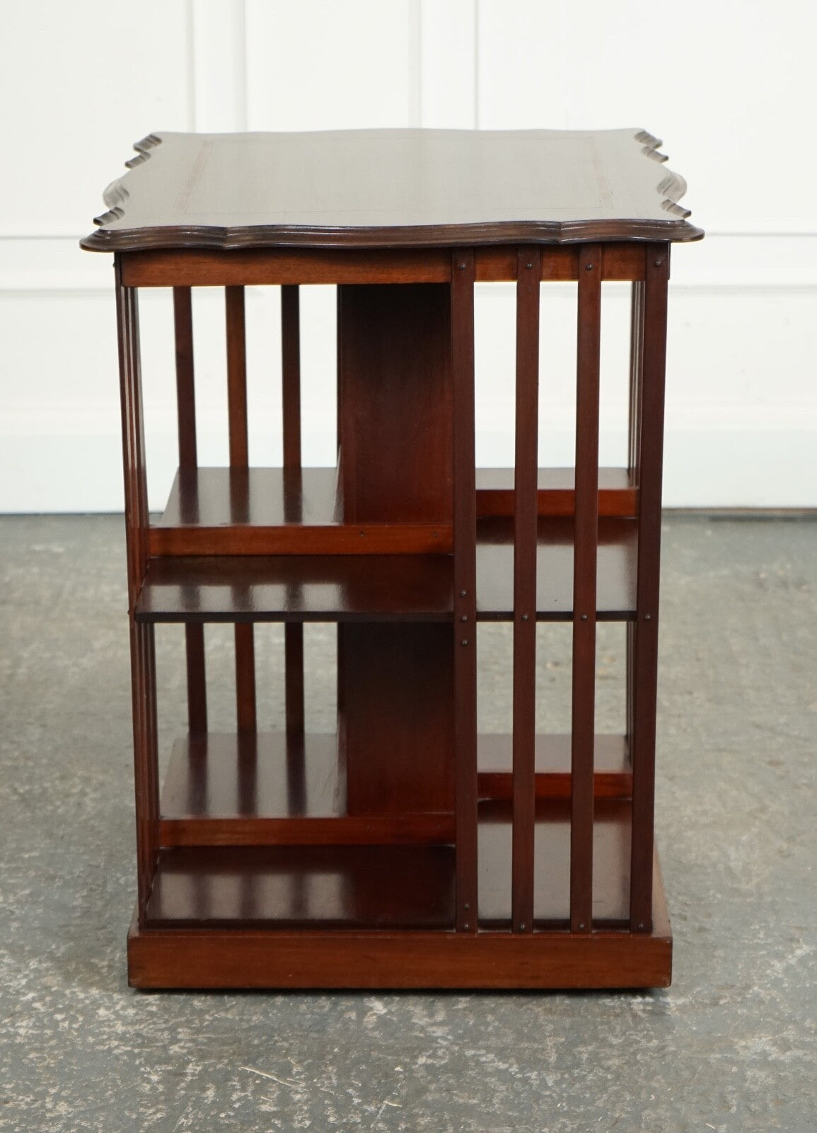 ANTIQUE EDWARDIAN REVOLVING BOOKCASE WITH A SERPENTINE SHAPED TOP