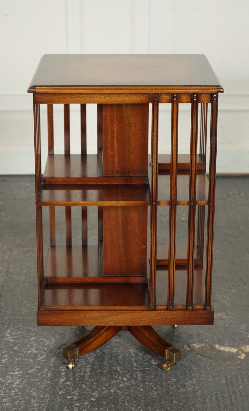 BEVAN FUNNEL REVOLVING BOOKCASE END TABLE RAISED ON BRASS CASTORS