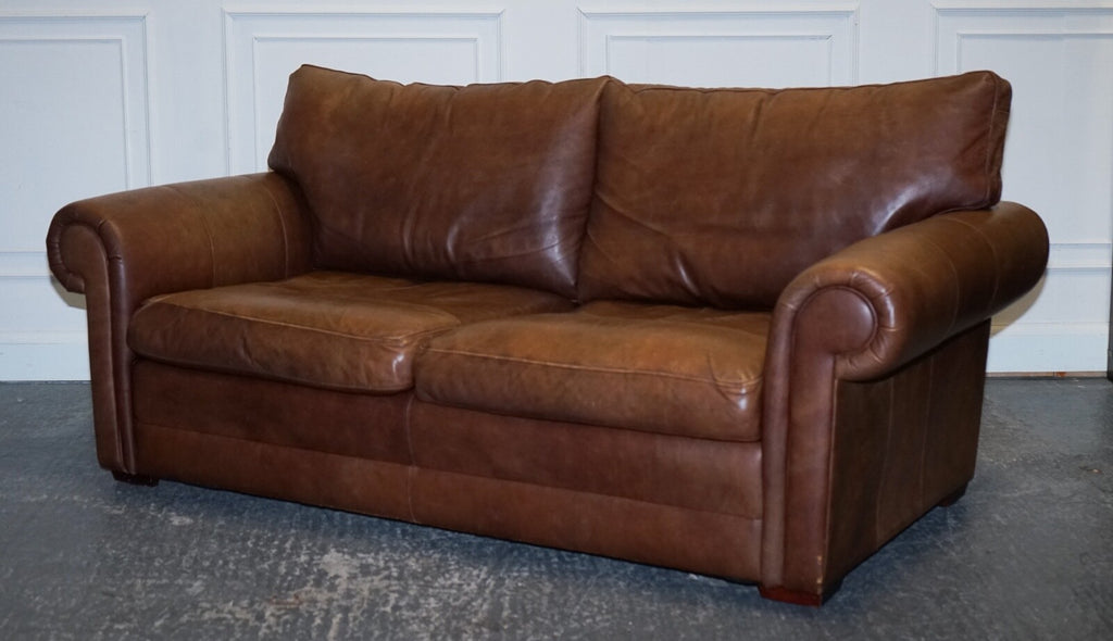 COMFORTABLE BROWN LEATHER TWO TO THREE SEATER SOFA WITH FEATHER BACK CUSHIONS