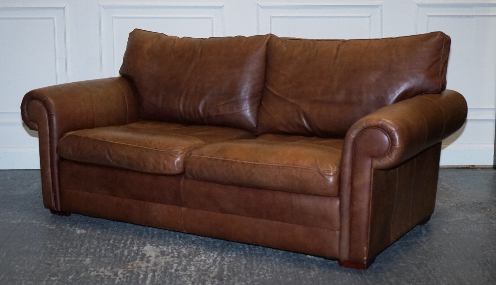 COMFORTABLE BROWN LEATHER TWO TO THREE SEATER SOFA WITH FEATHER BACK CUSHIONS