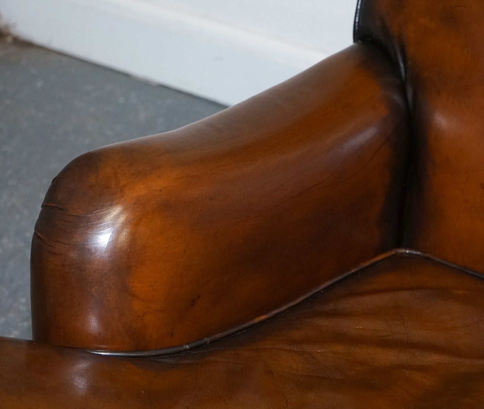 PAIR OF CIGAR HAND DYED LEATHER HOWARD & SONS STYLE ARMCHAIRS ON CASTOR FEET