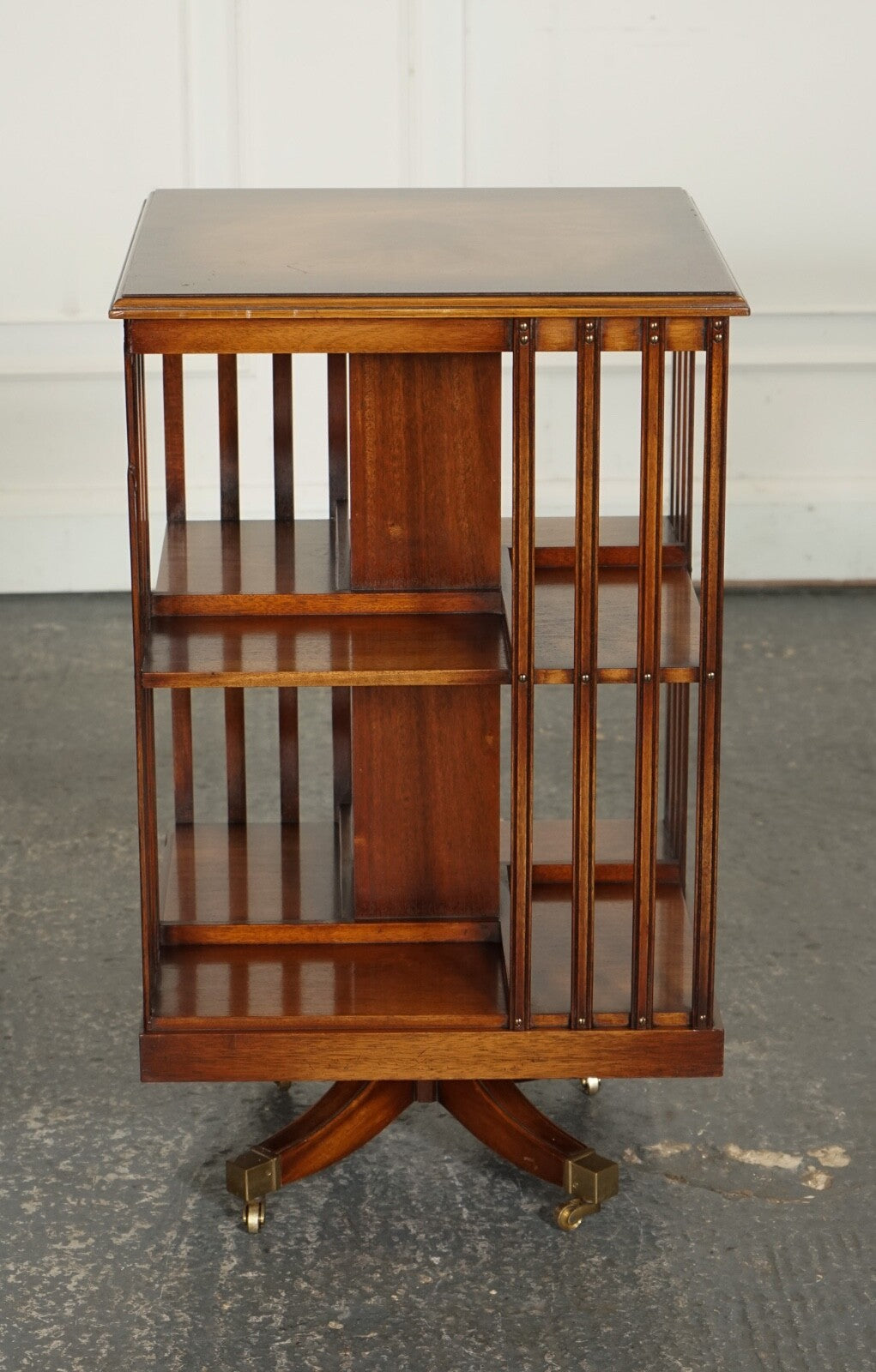 BEVAN FUNNEL REVOLVING BOOKCASE END TABLE RAISED ON BRASS CASTORS