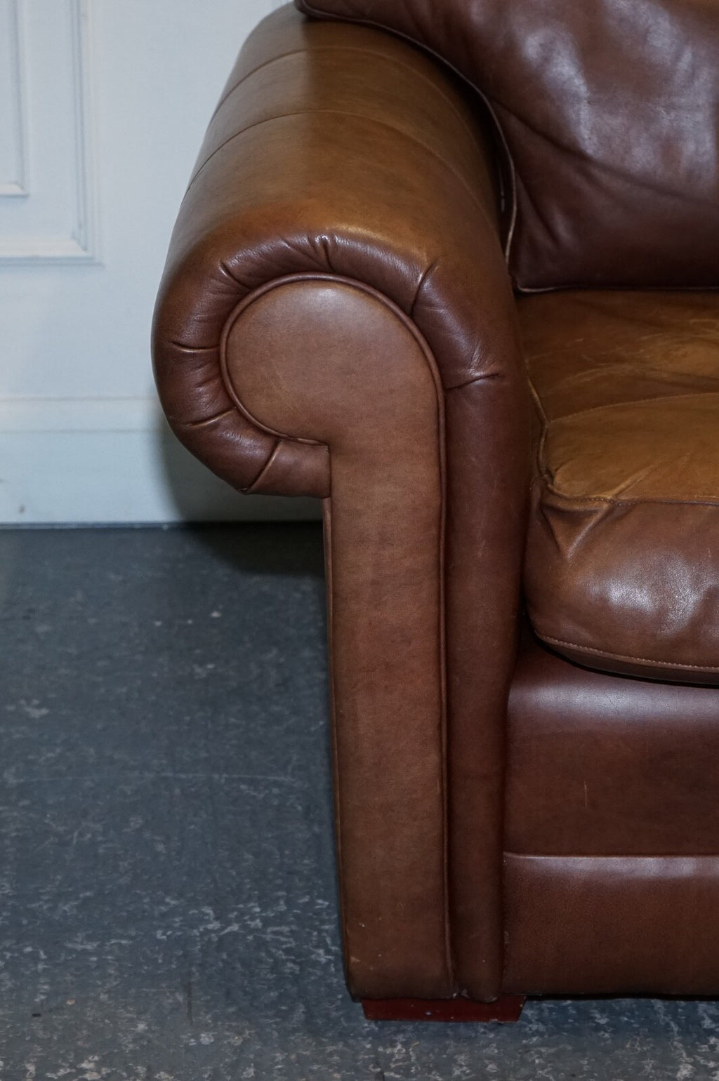 COMFORTABLE BROWN LEATHER TWO TO THREE SEATER SOFA WITH FEATHER BACK CUSHIONS