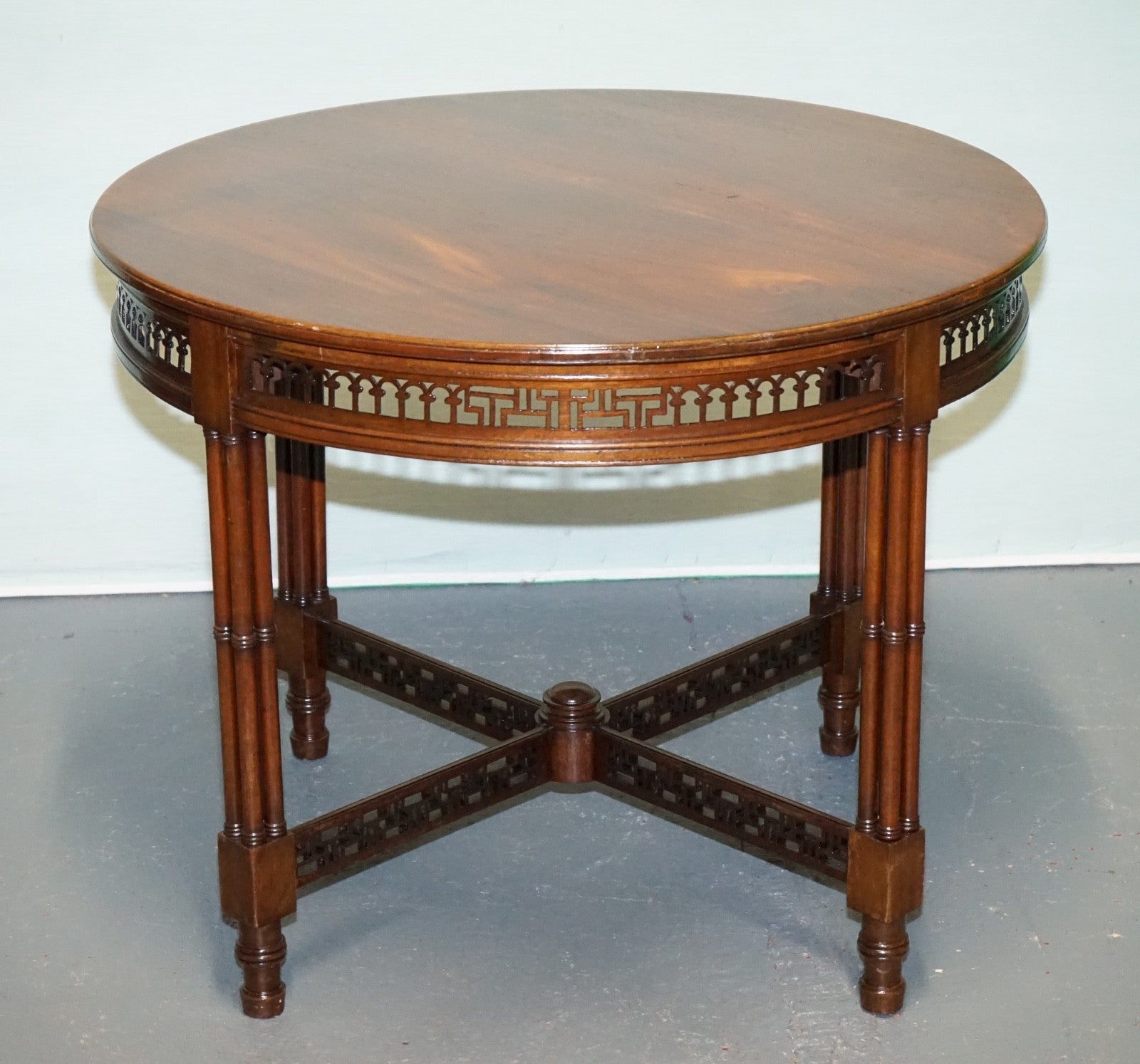 LATE 19TH CENTURY CHIPPENDALE STYLE ROUND OCCASIONAL TABLE AND CARVED STRETCHERS