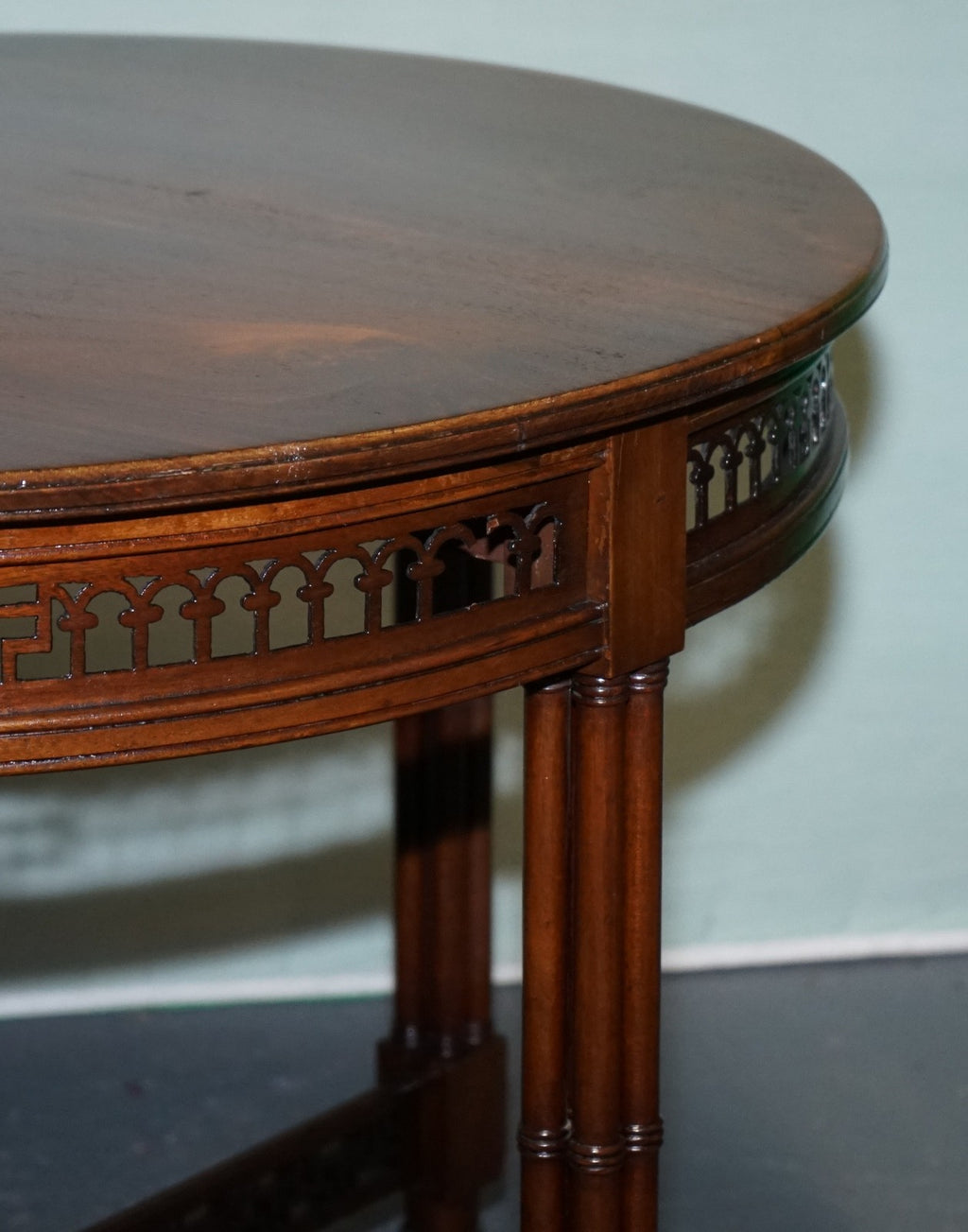 LATE 19TH CENTURY CHIPPENDALE STYLE ROUND OCCASIONAL TABLE AND CARVED STRETCHERS