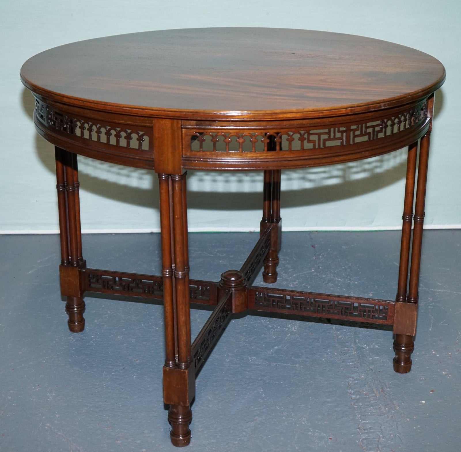 LATE 19TH CENTURY CHIPPENDALE STYLE ROUND OCCASIONAL TABLE AND CARVED STRETCHERS