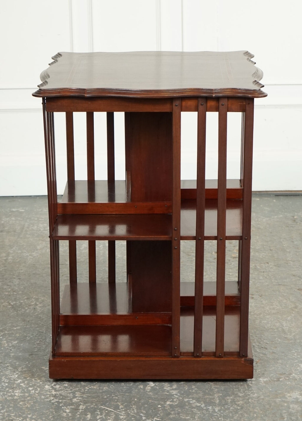 ANTIQUE EDWARDIAN REVOLVING BOOKCASE WITH A SERPENTINE SHAPED TOP