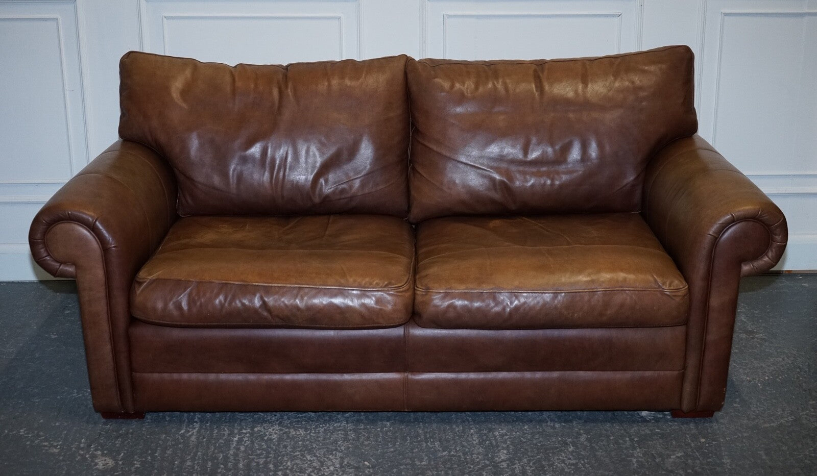 COMFORTABLE BROWN LEATHER TWO TO THREE SEATER SOFA WITH FEATHER BACK CUSHIONS