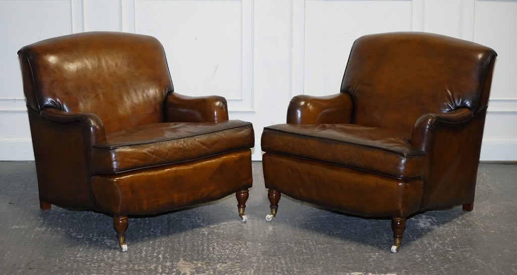 PAIR OF CIGAR HAND DYED LEATHER HOWARD & SONS STYLE ARMCHAIRS ON CASTOR FEET