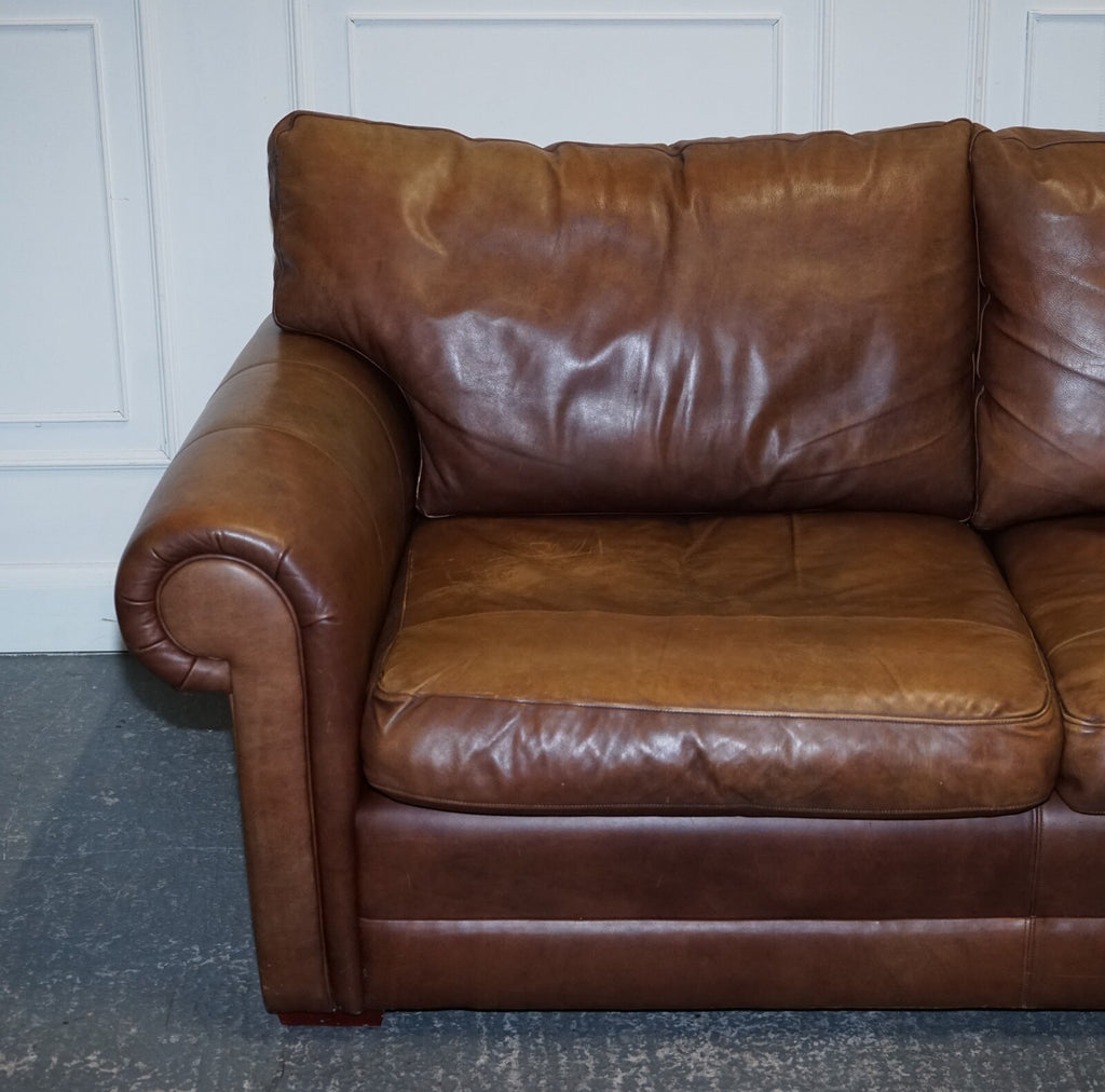 COMFORTABLE BROWN LEATHER TWO TO THREE SEATER SOFA WITH FEATHER BACK CUSHIONS