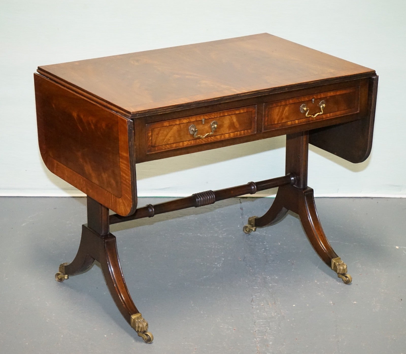VINTAGE HARDWOOD DROP LEAF SIDE TABLE WITH SABER LEGS AND BRASS PAW FEET