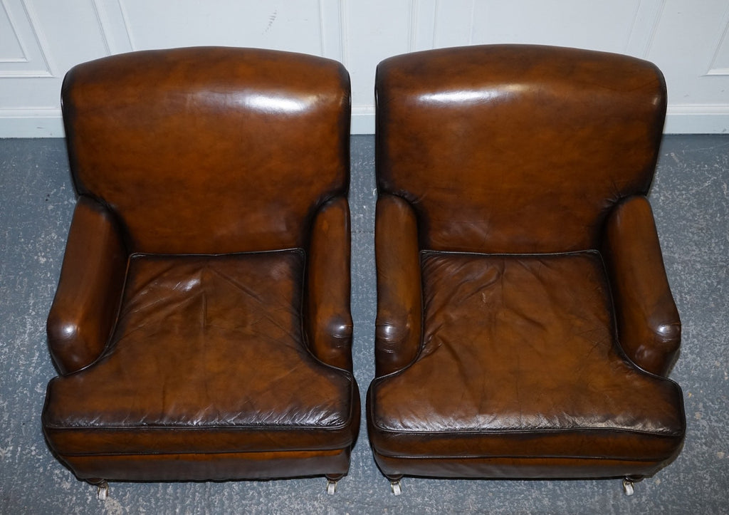 PAIR OF CIGAR HAND DYED LEATHER HOWARD & SONS STYLE ARMCHAIRS ON CASTOR FEET