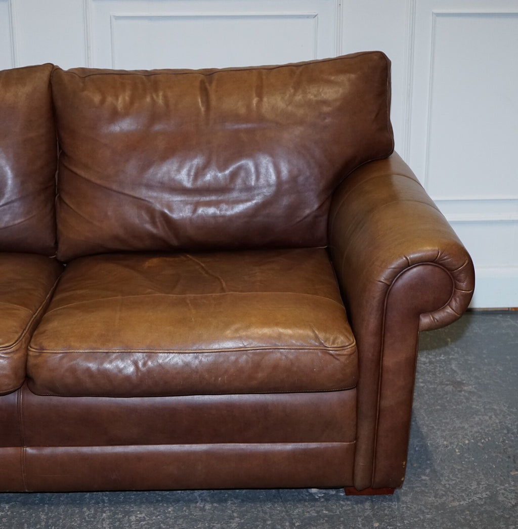 COMFORTABLE BROWN LEATHER TWO TO THREE SEATER SOFA WITH FEATHER BACK CUSHIONS