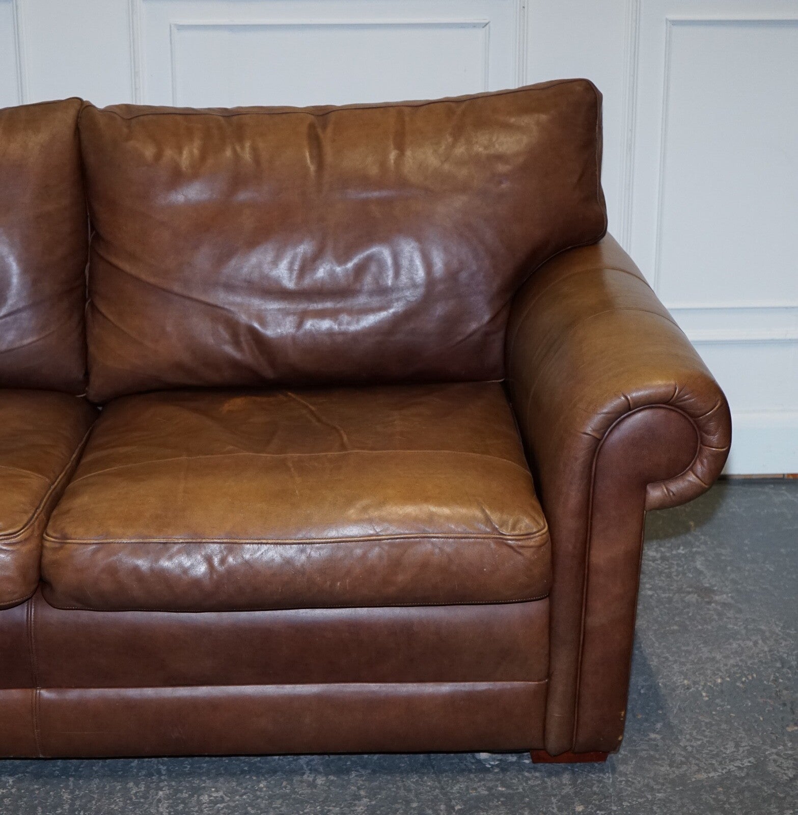 COMFORTABLE BROWN LEATHER TWO TO THREE SEATER SOFA WITH FEATHER BACK CUSHIONS