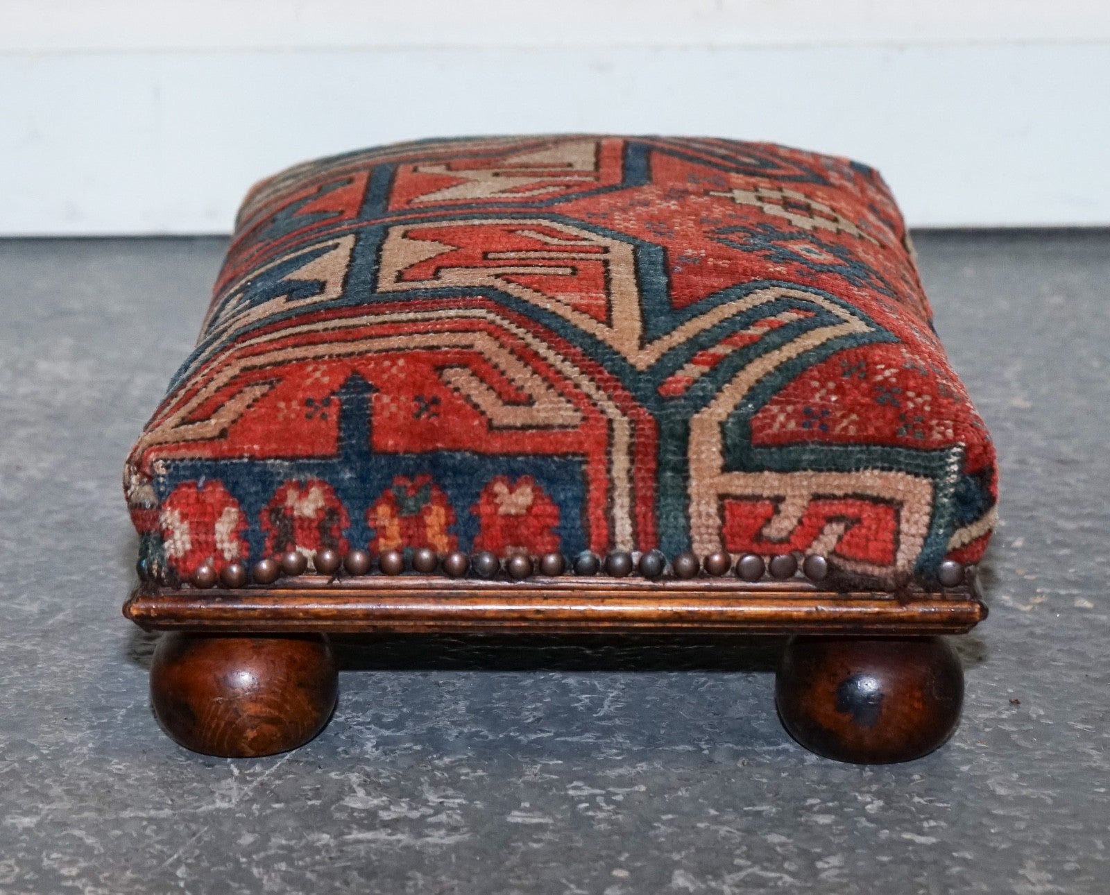 ANTIQUE KILIM TRIBAL RUG UPHOLSTERED FOOTSTOOL RAISED ON BUN FEET WITH STUDS