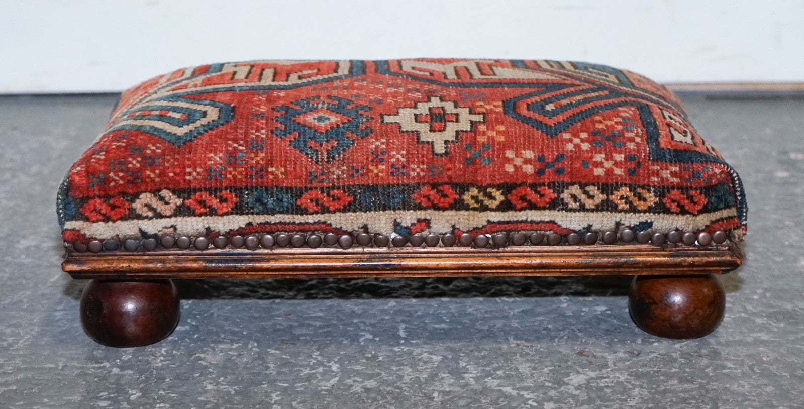 ANTIQUE KILIM TRIBAL RUG UPHOLSTERED FOOTSTOOL RAISED ON BUN FEET WITH STUDS