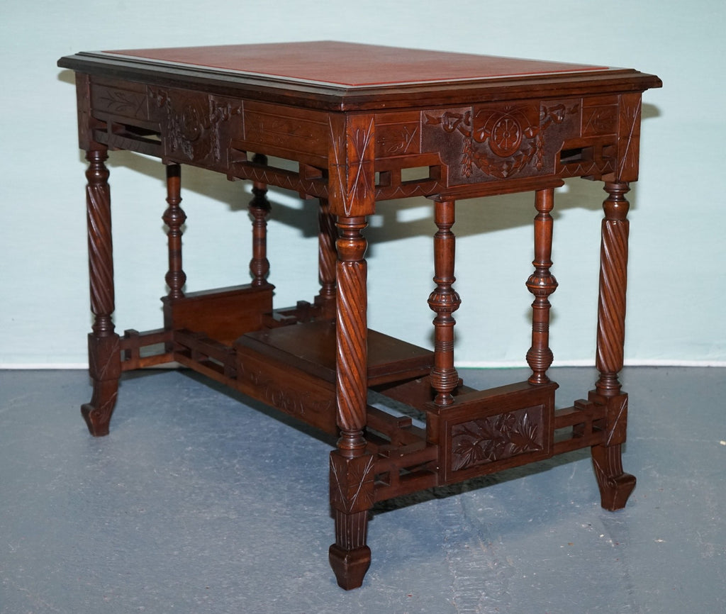 LATE 19TH CENTURY CONTINENTAL CARVED WALNUT WRITING TABLE LEATHER INLAY TOP
