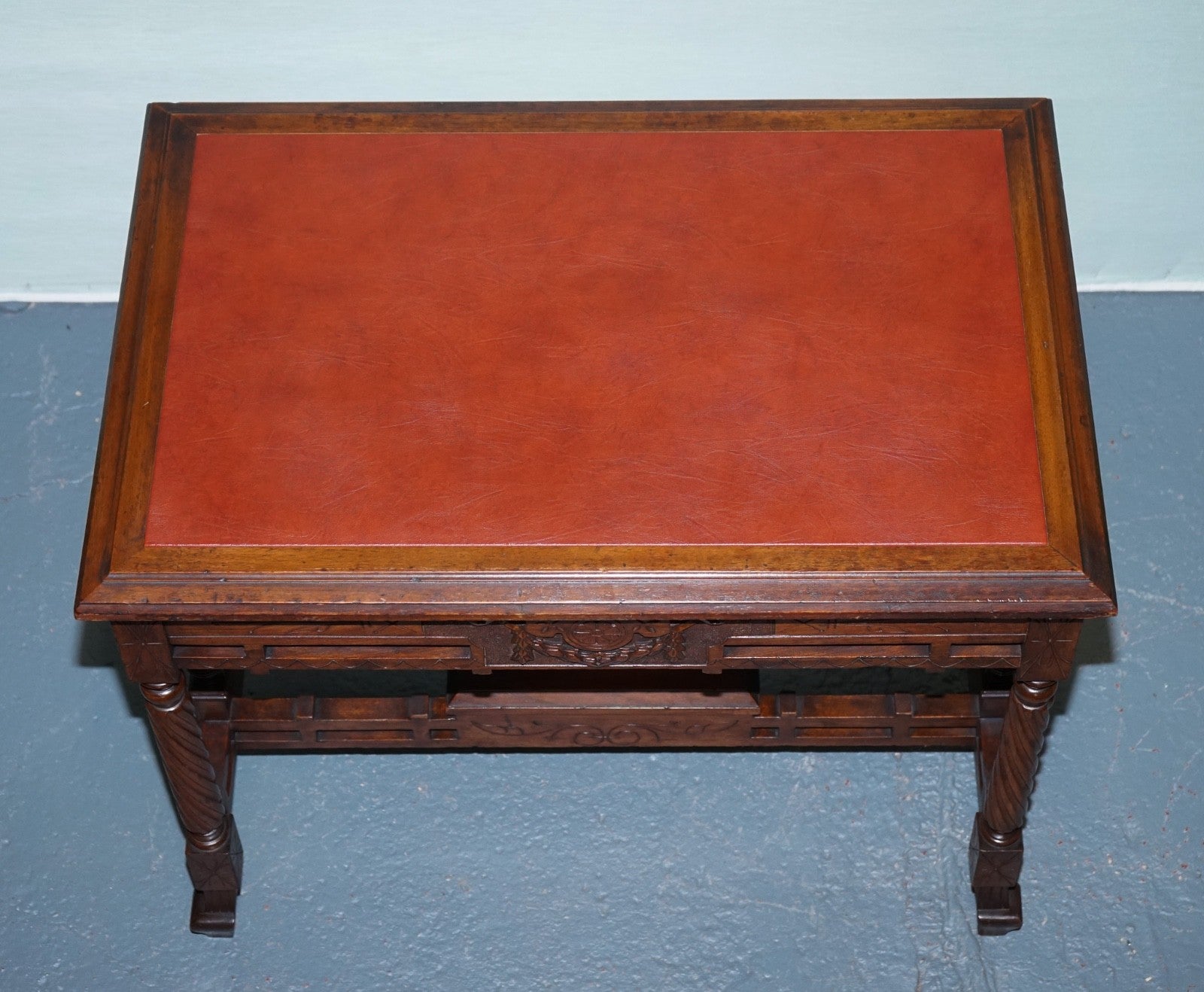 LATE 19TH CENTURY CONTINENTAL CARVED WALNUT WRITING TABLE LEATHER INLAY TOP
