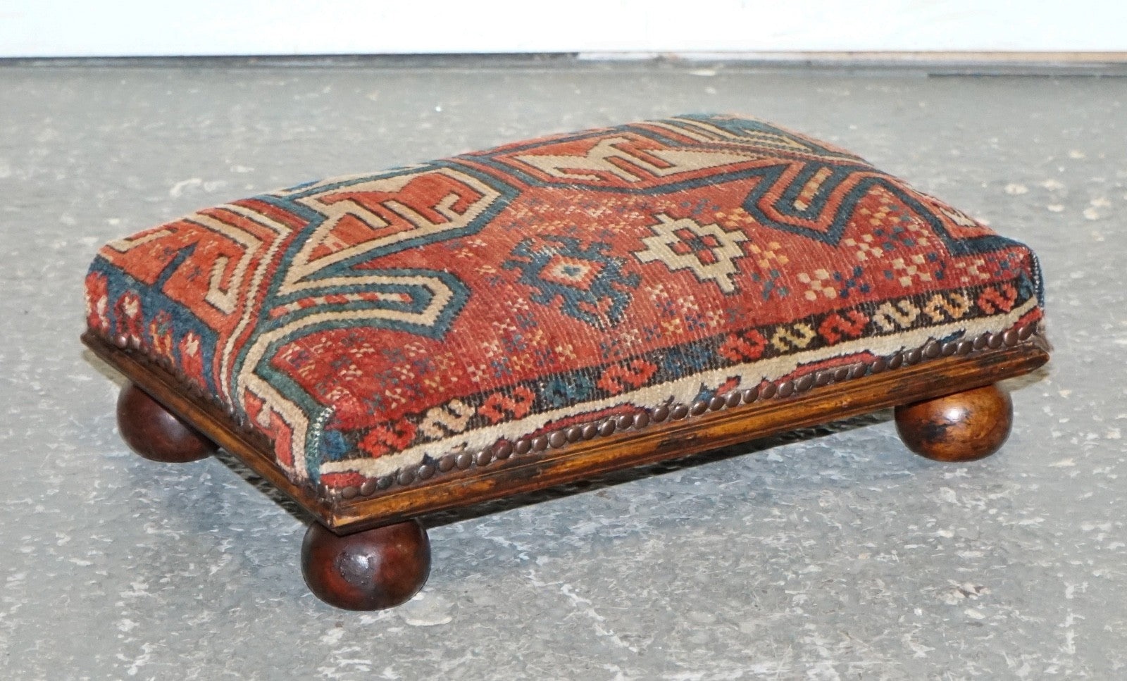 ANTIQUE KILIM TRIBAL RUG UPHOLSTERED FOOTSTOOL RAISED ON BUN FEET WITH STUDS