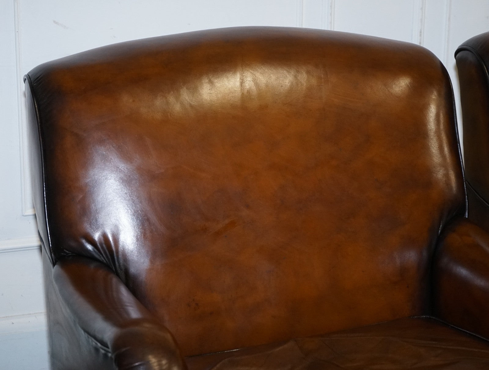 PAIR OF CIGAR HAND DYED LEATHER HOWARD & SONS STYLE ARMCHAIRS ON CASTOR FEET