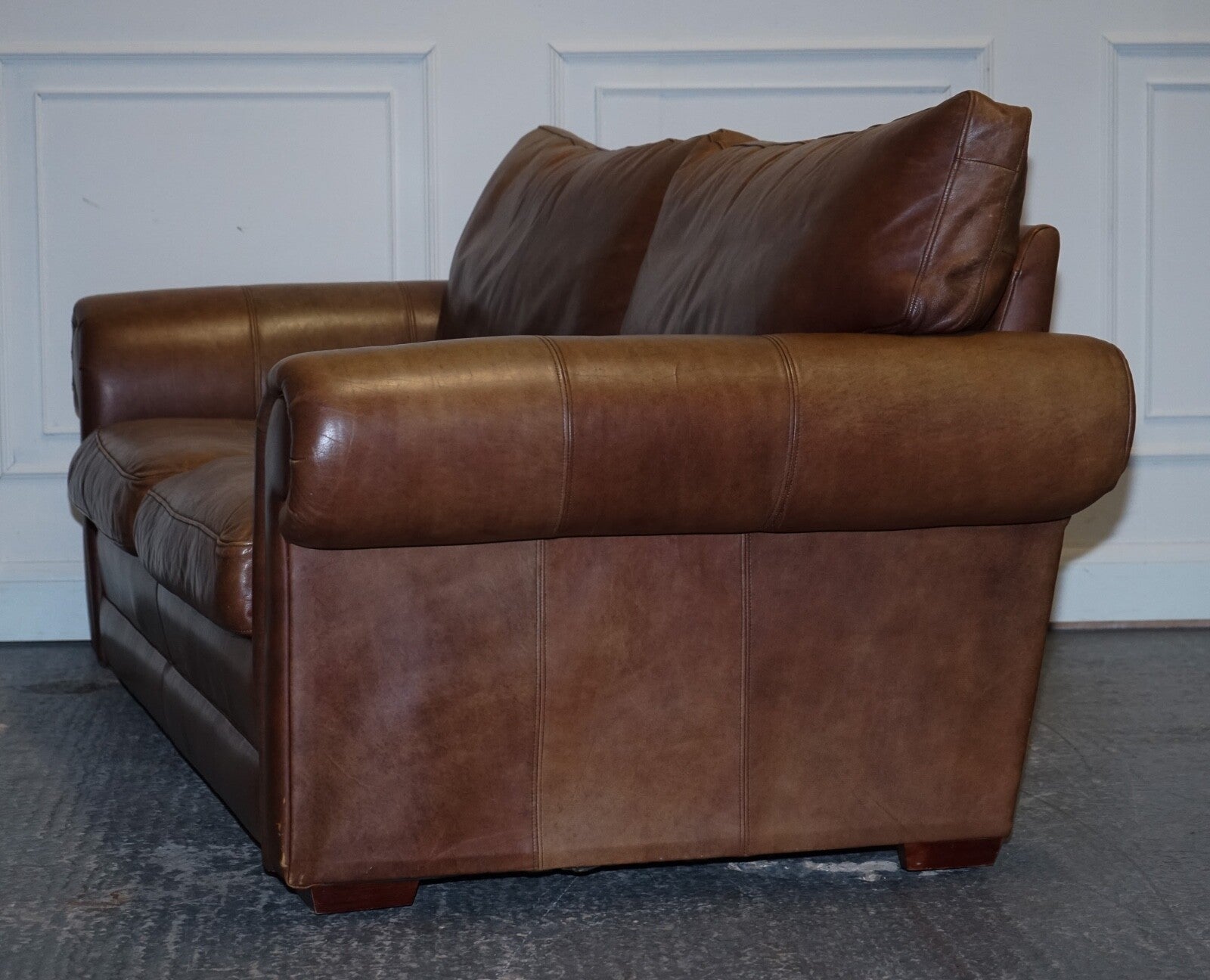 COMFORTABLE BROWN LEATHER TWO TO THREE SEATER SOFA WITH FEATHER BACK CUSHIONS