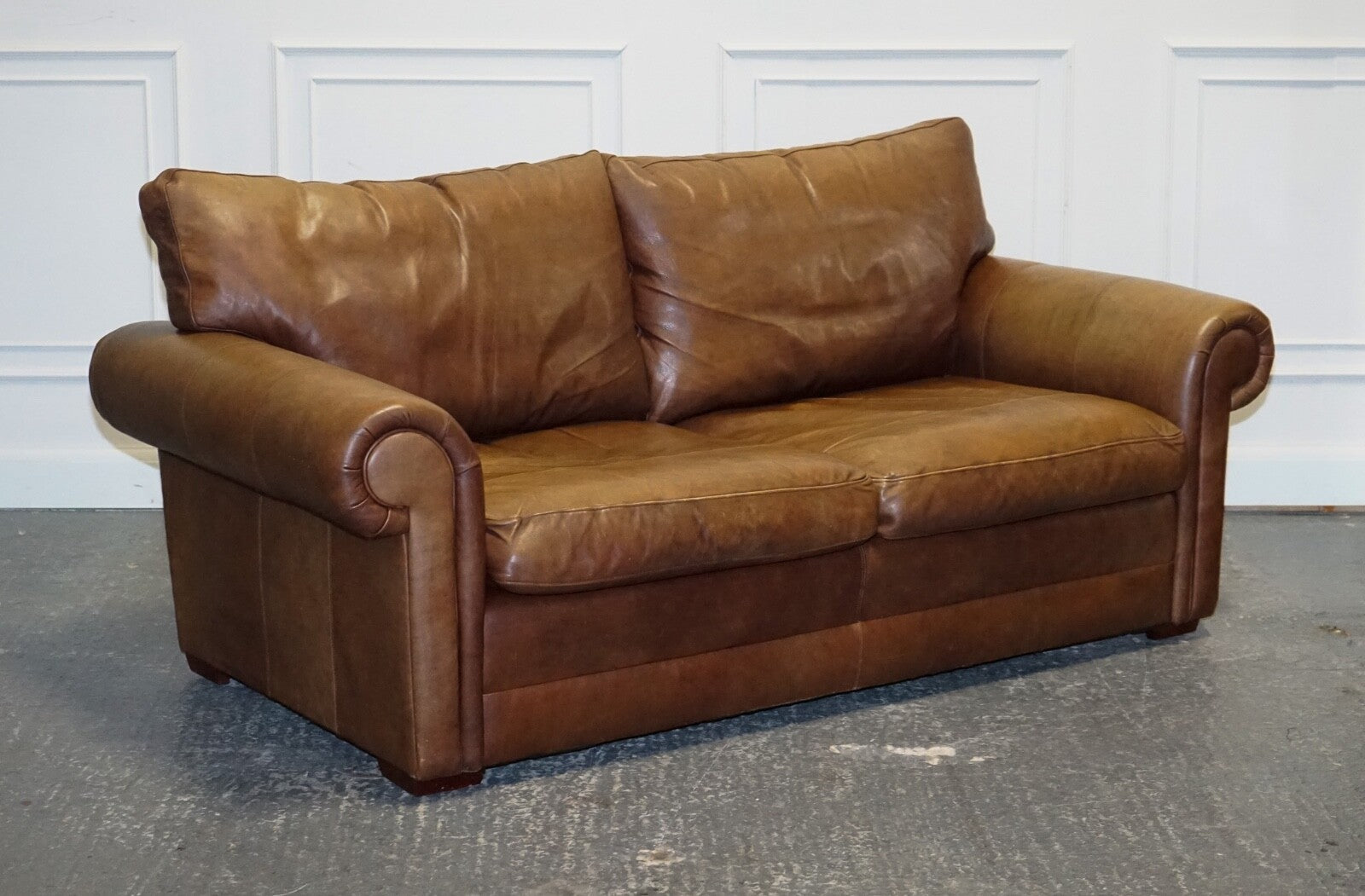 COMFORTABLE BROWN LEATHER TWO TO THREE SEATER SOFA WITH FEATHER BACK CUSHIONS
