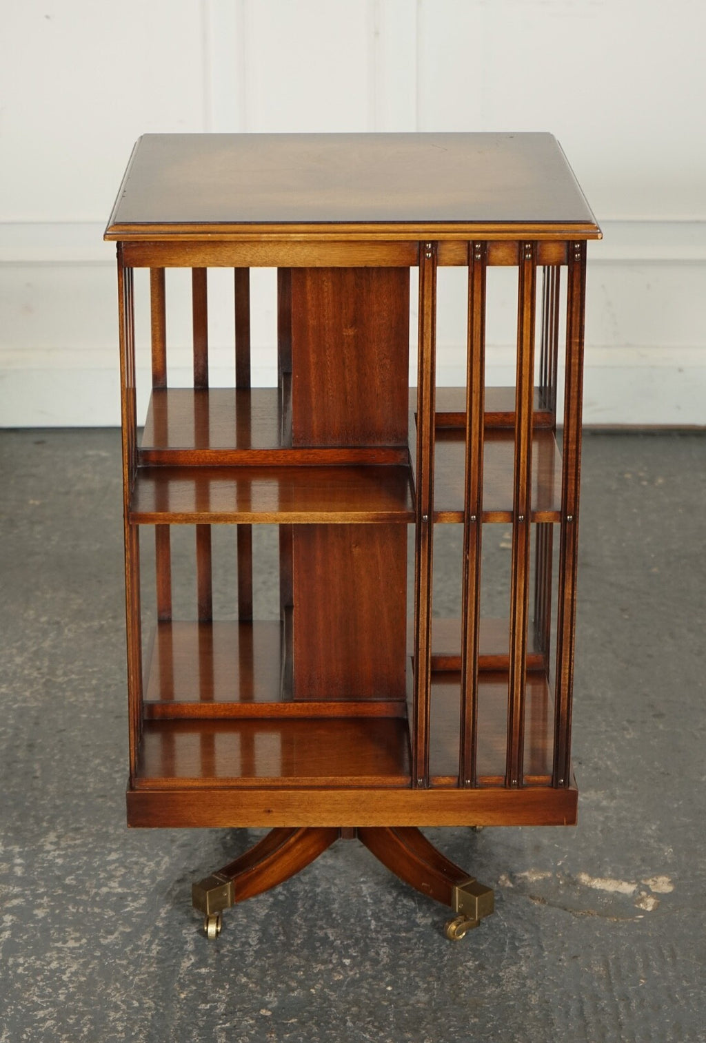 BEVAN FUNNEL REVOLVING BOOKCASE END TABLE RAISED ON BRASS CASTORS