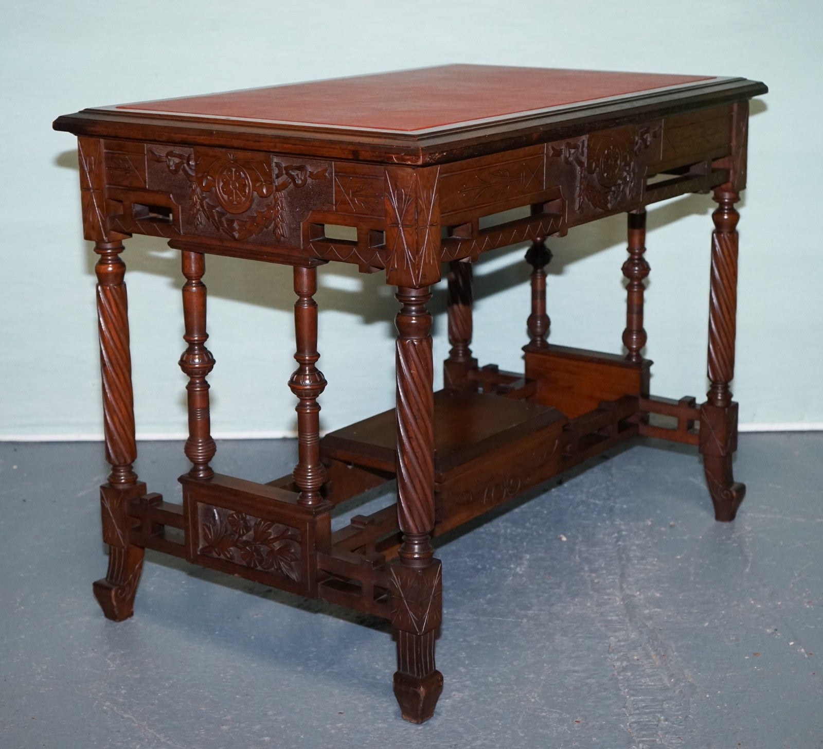LATE 19TH CENTURY CONTINENTAL CARVED WALNUT WRITING TABLE LEATHER INLAY TOP