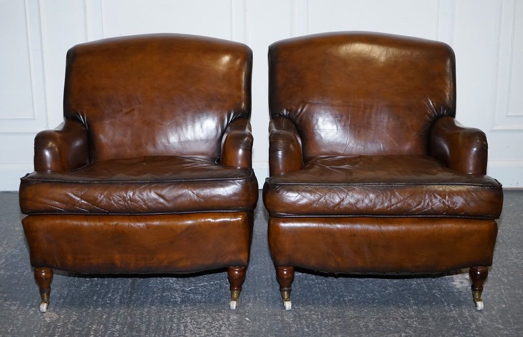PAIR OF CIGAR HAND DYED LEATHER HOWARD & SONS STYLE ARMCHAIRS ON CASTOR FEET