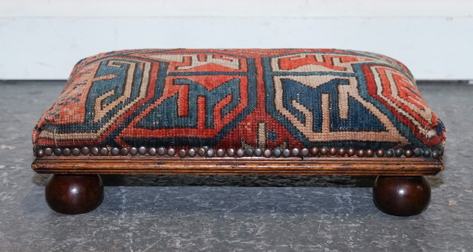 ANTIQUE KILIM TRIBAL RUG UPHOLSTERED FOOTSTOOL RAISED ON BUN FEET WITH STUDS