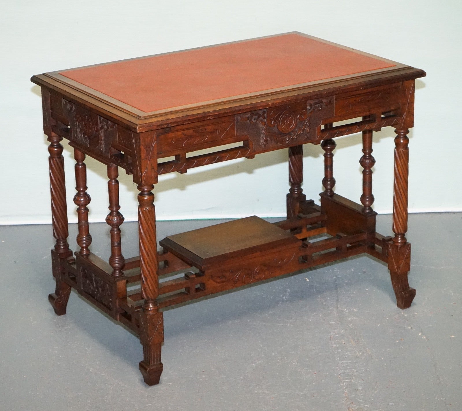 LATE 19TH CENTURY CONTINENTAL CARVED WALNUT WRITING TABLE LEATHER INLAY TOP
