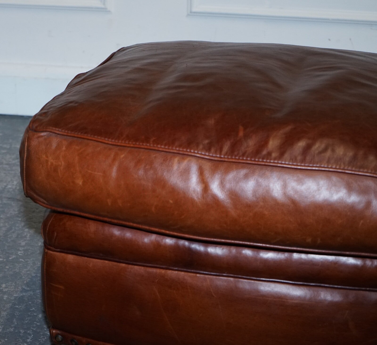 LOVELY VINTAGE BROWN LEATHER FOOTSTOOL FEATHER FILLED BRASS STUDS DETAIL