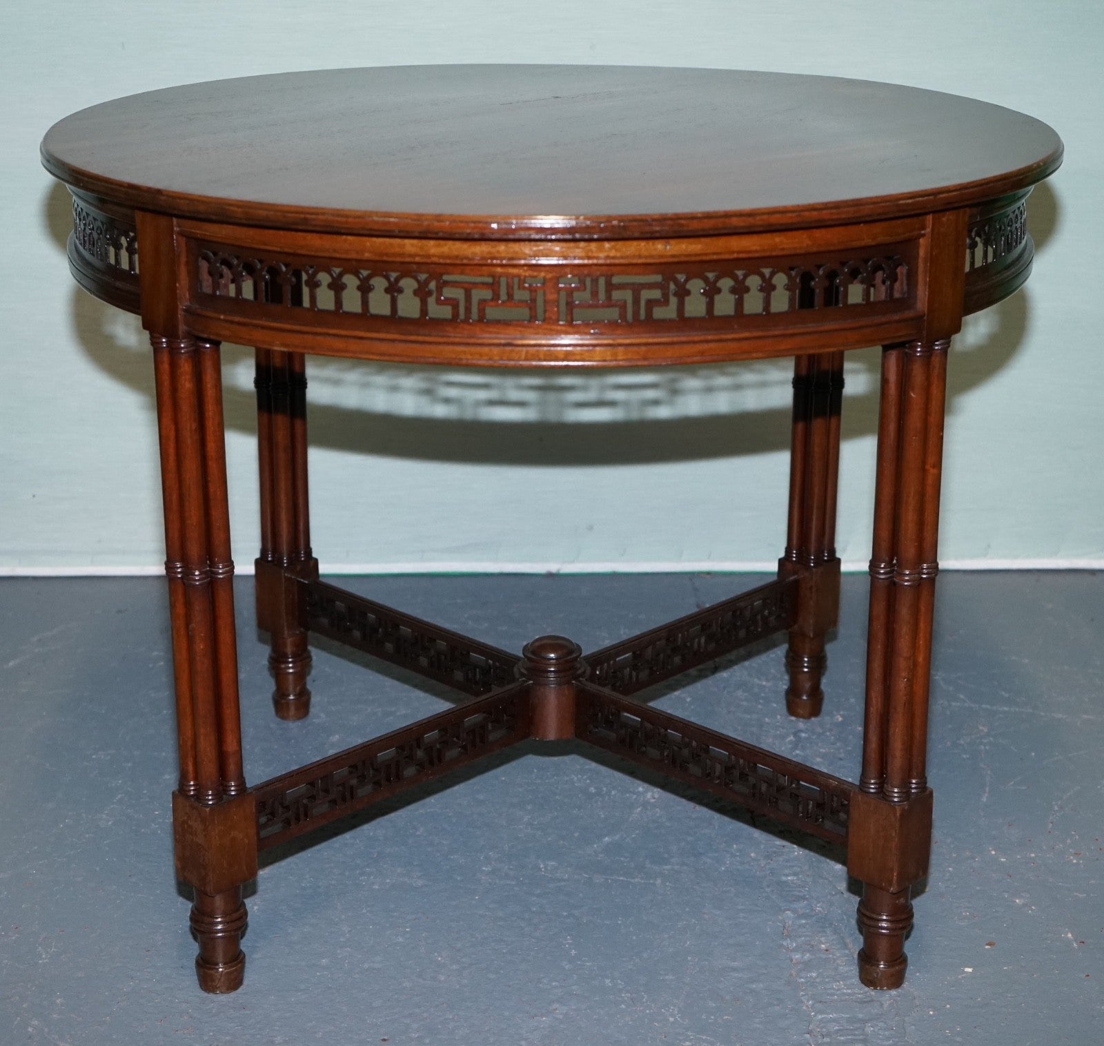 LATE 19TH CENTURY CHIPPENDALE STYLE ROUND OCCASIONAL TABLE AND CARVED STRETCHERS