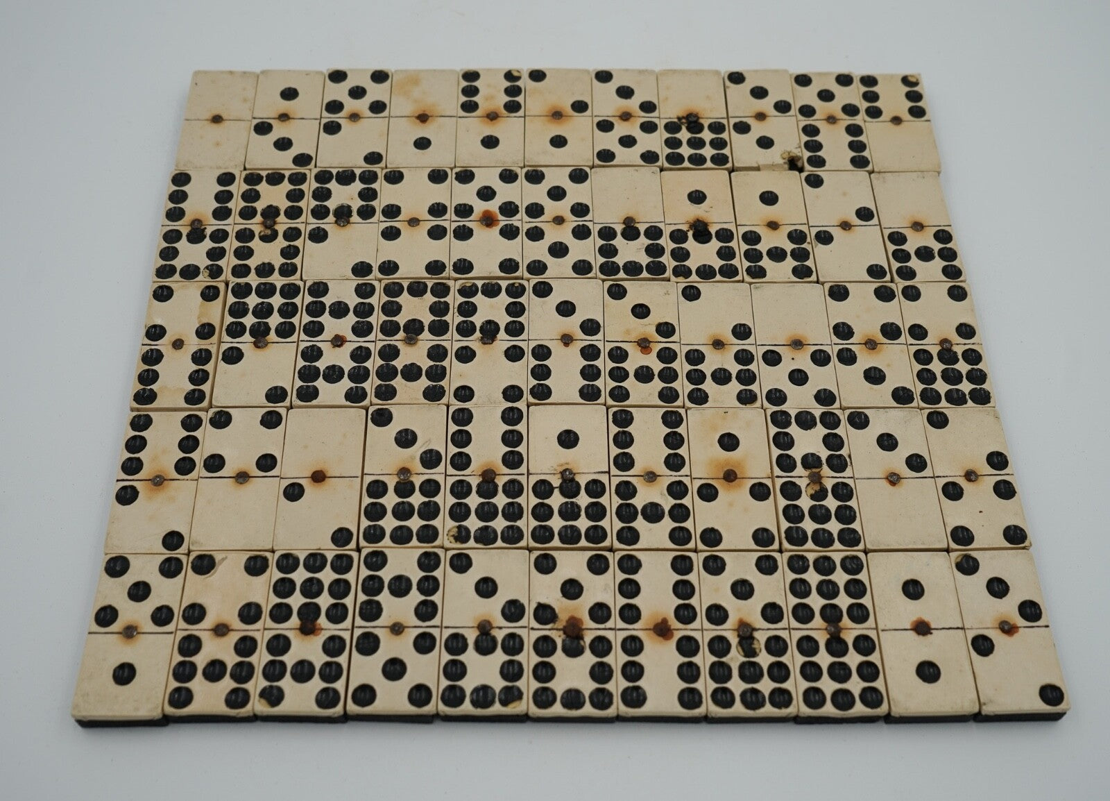 LATE 19TH CENTURY BOX OF TRADITIONAL GAME NINER DOMINOS WITH STUNNING PATINA