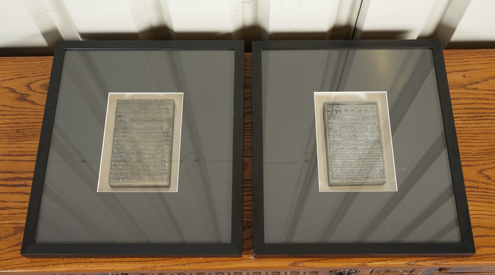 PAIR OF ARABIC WRITINGS FRAMED IN MODERN BLACK FRAMES