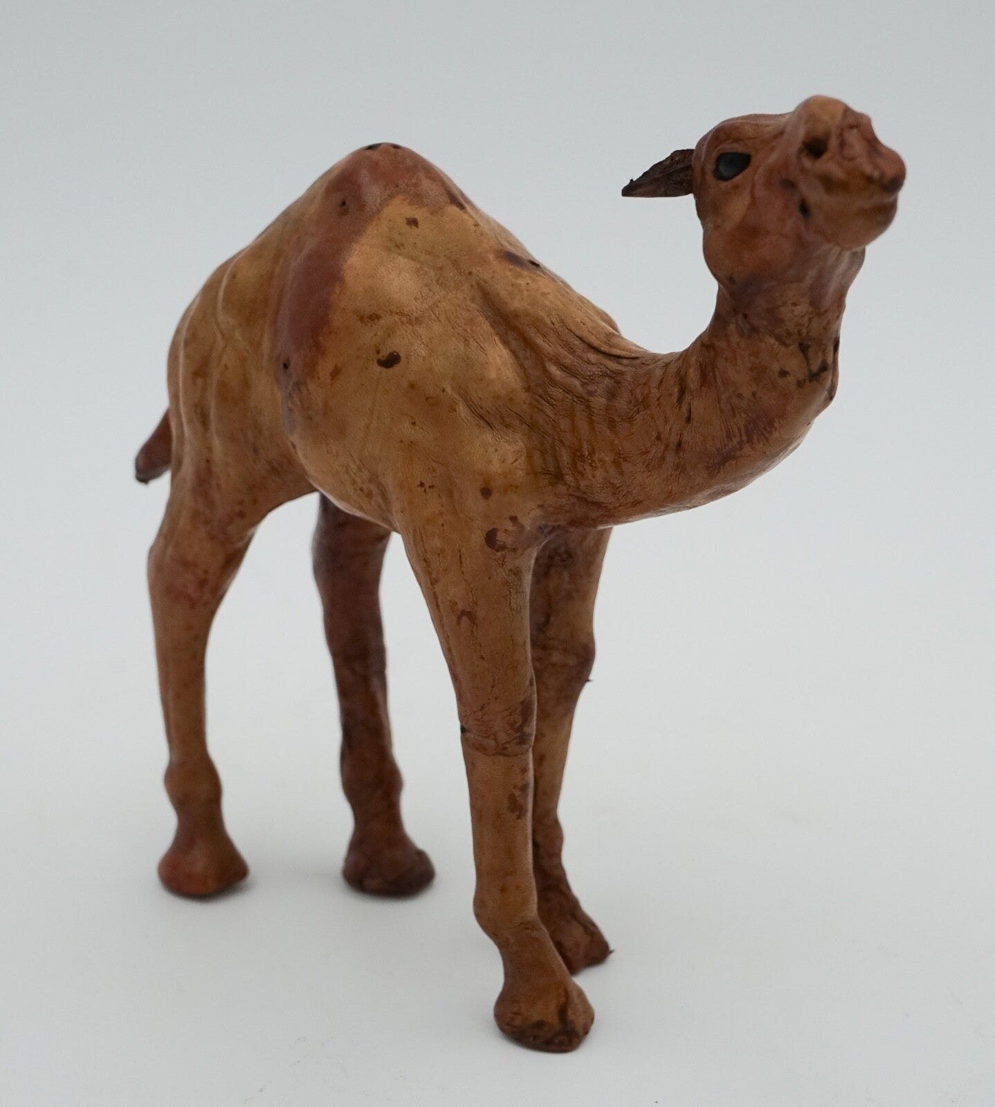 CAMEL SCULPTURE WITH  AGED LEATHER ON HAND CARVED WOOD BY LIBERTY'S LONDON