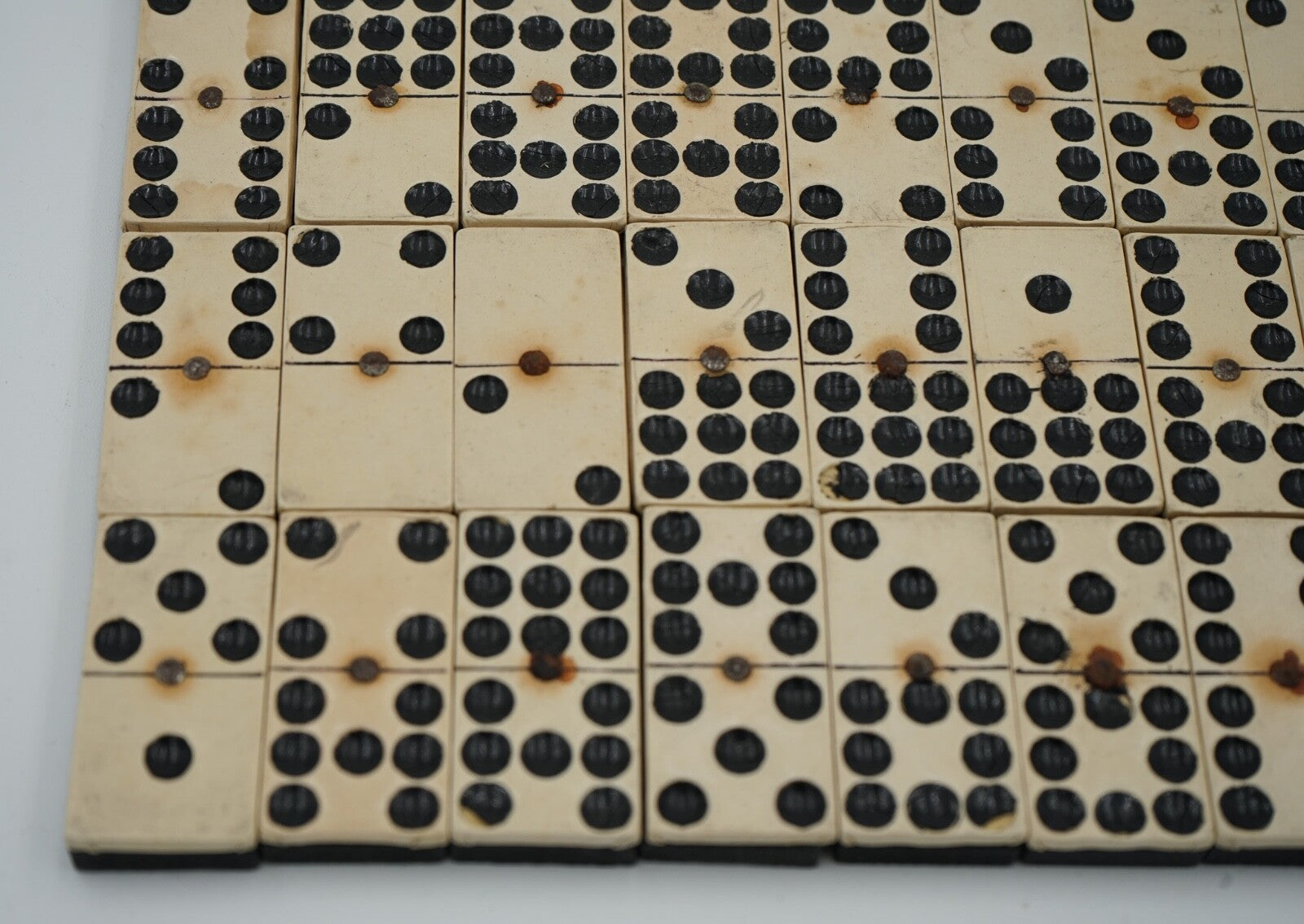 LATE 19TH CENTURY BOX OF TRADITIONAL GAME NINER DOMINOS WITH STUNNING PATINA