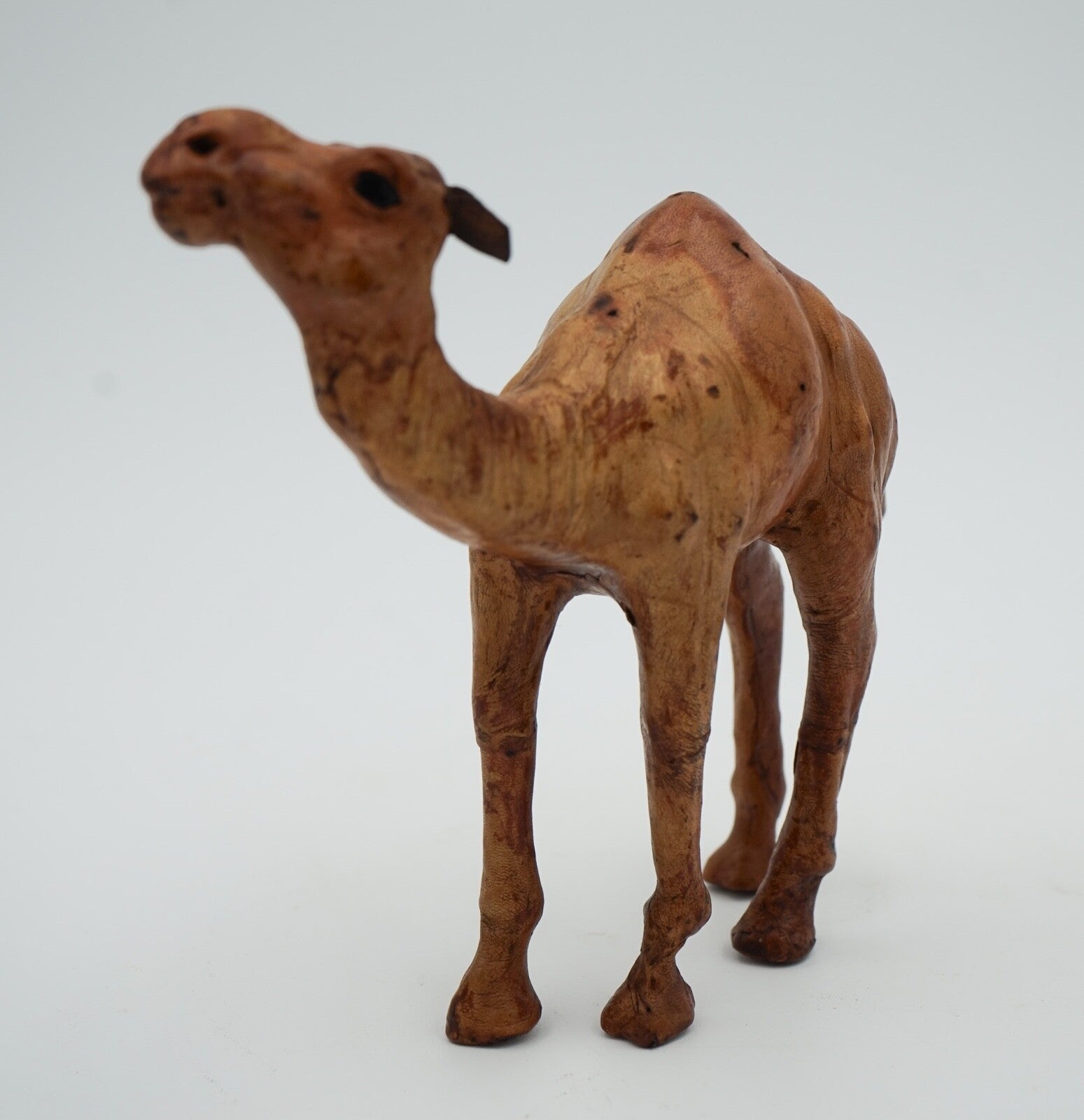 CAMEL SCULPTURE WITH  AGED LEATHER ON HAND CARVED WOOD BY LIBERTY'S LONDON