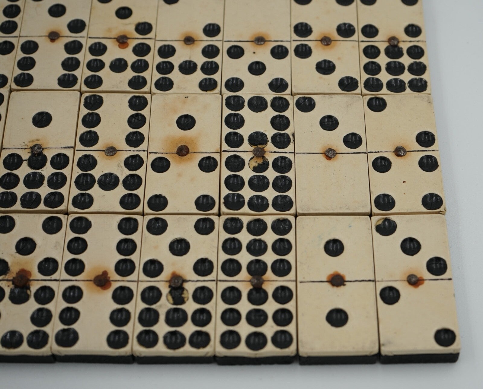 LATE 19TH CENTURY BOX OF TRADITIONAL GAME NINER DOMINOS WITH STUNNING PATINA