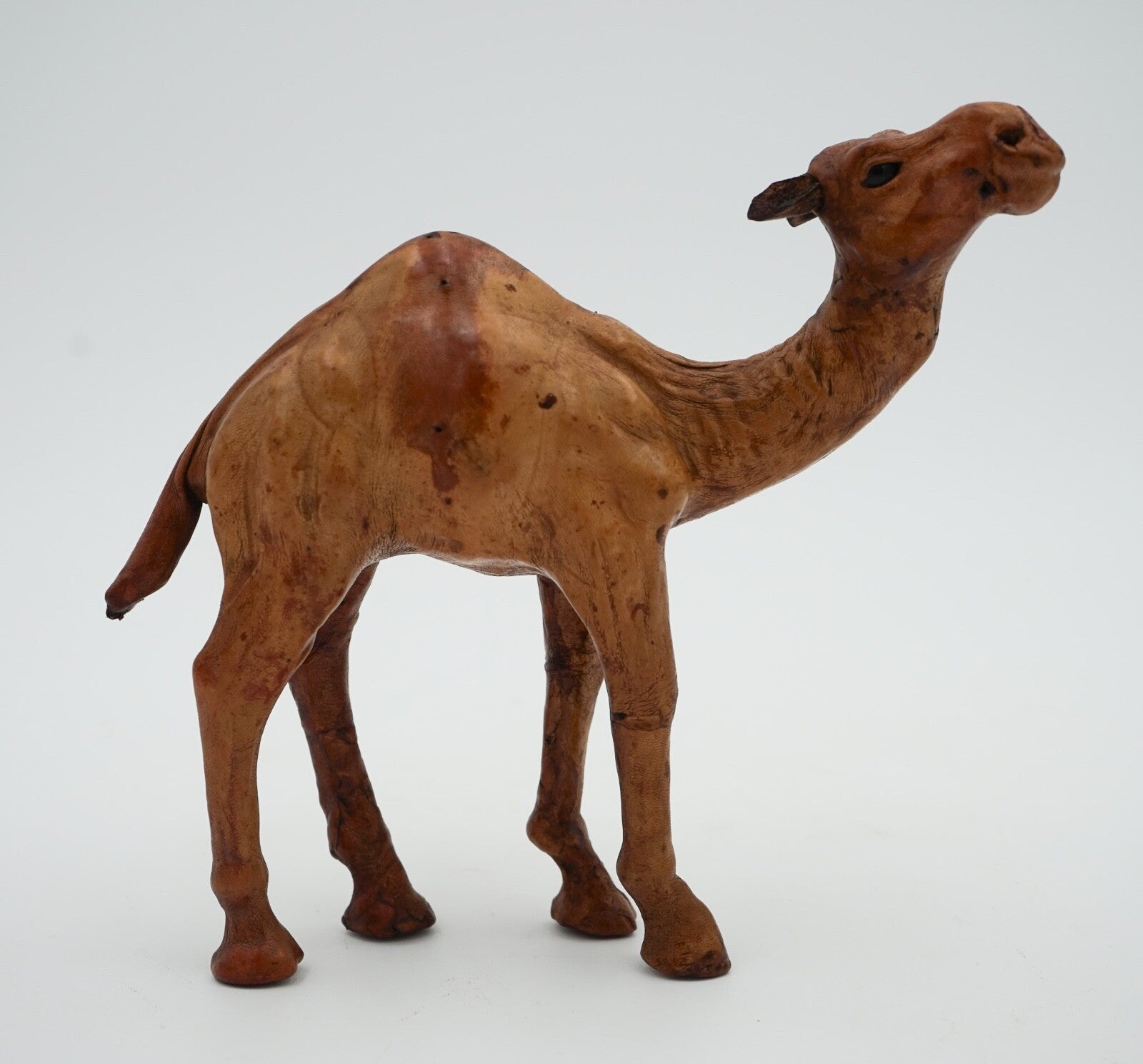 CAMEL SCULPTURE WITH  AGED LEATHER ON HAND CARVED WOOD BY LIBERTY'S LONDON