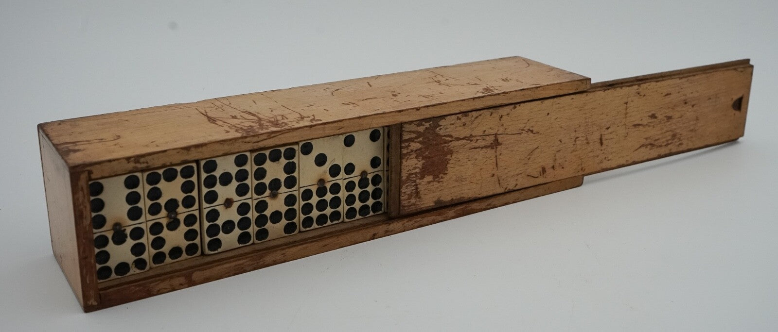 LATE 19TH CENTURY BOX OF TRADITIONAL GAME NINER DOMINOS WITH STUNNING PATINA
